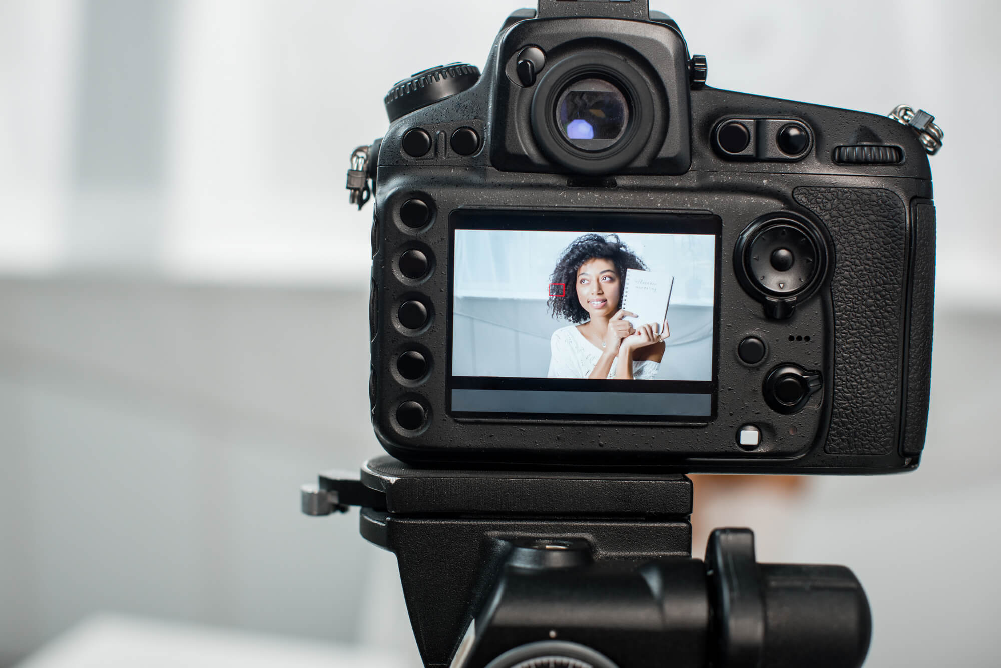 video camera with a woman on display screen, video marketing