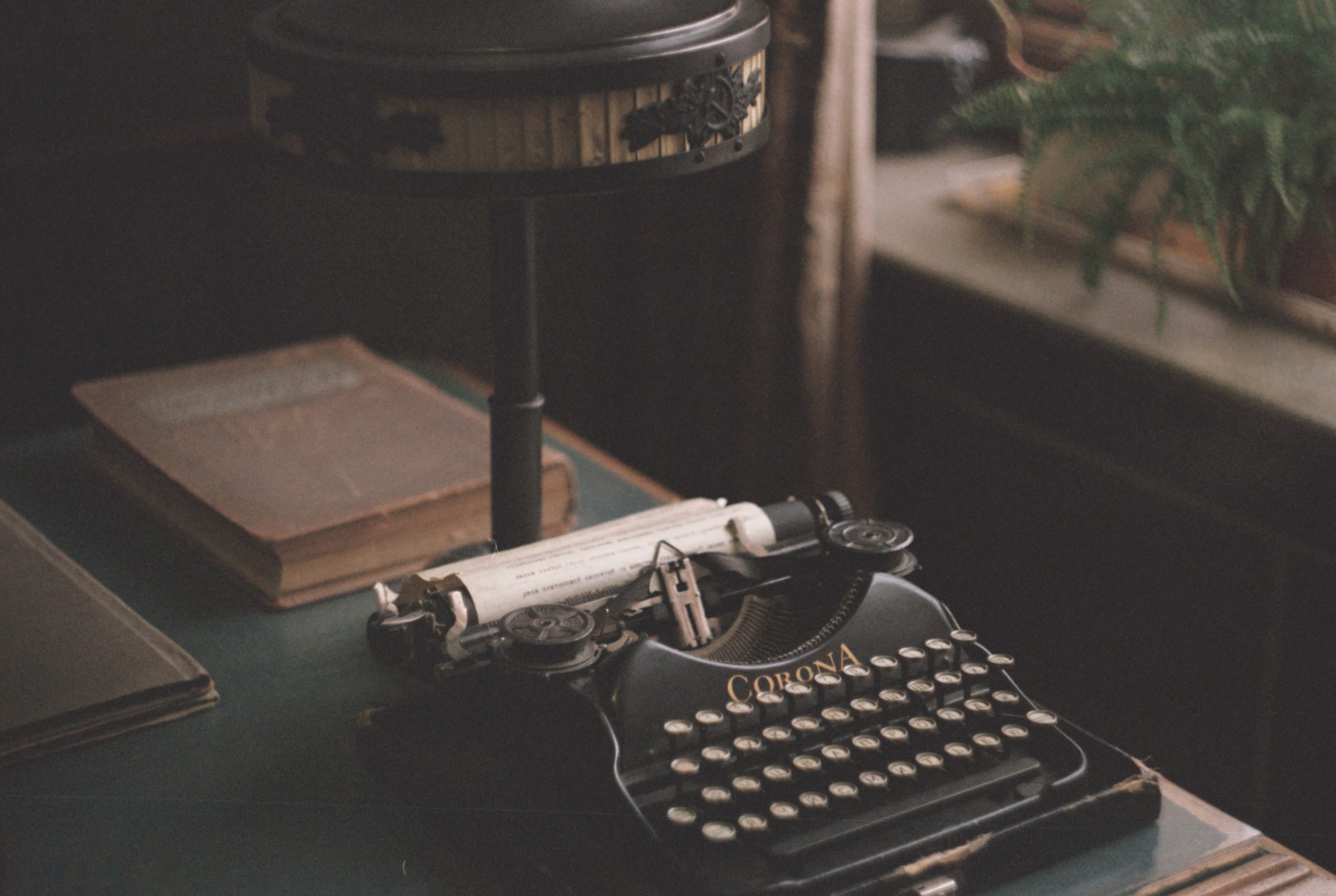 photo of old typewriter and lamp