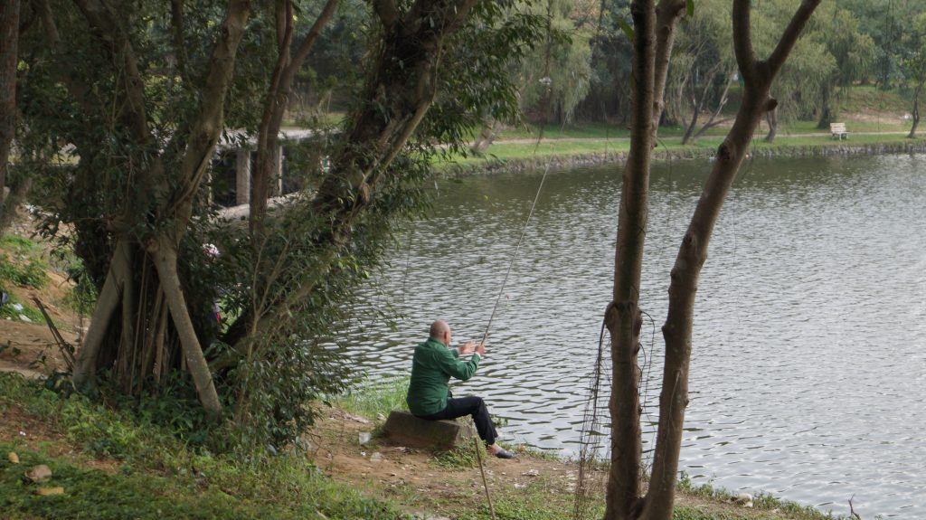 Image of a person fishing at a lake. Recognizing phishing is necessary to protect your business information online.