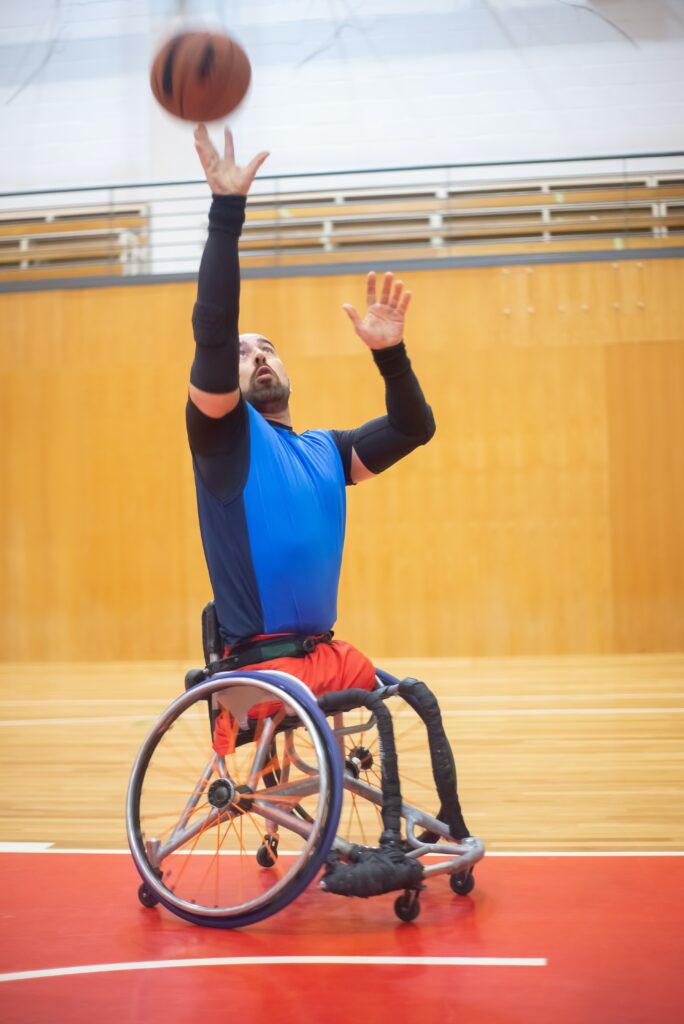 Disabled man in a wheelchair playing basketball