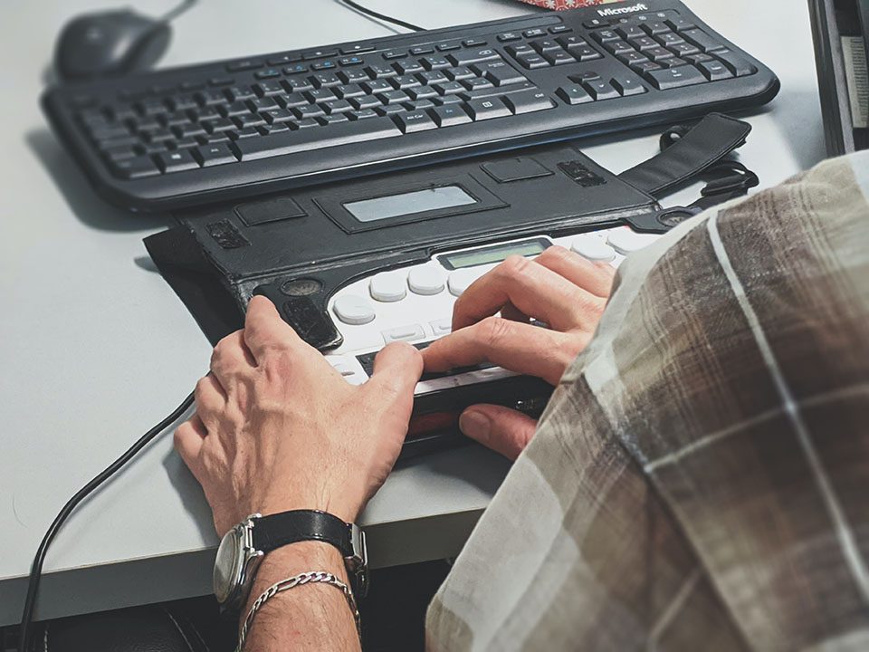 Disabled person using navigation assistance on their computer