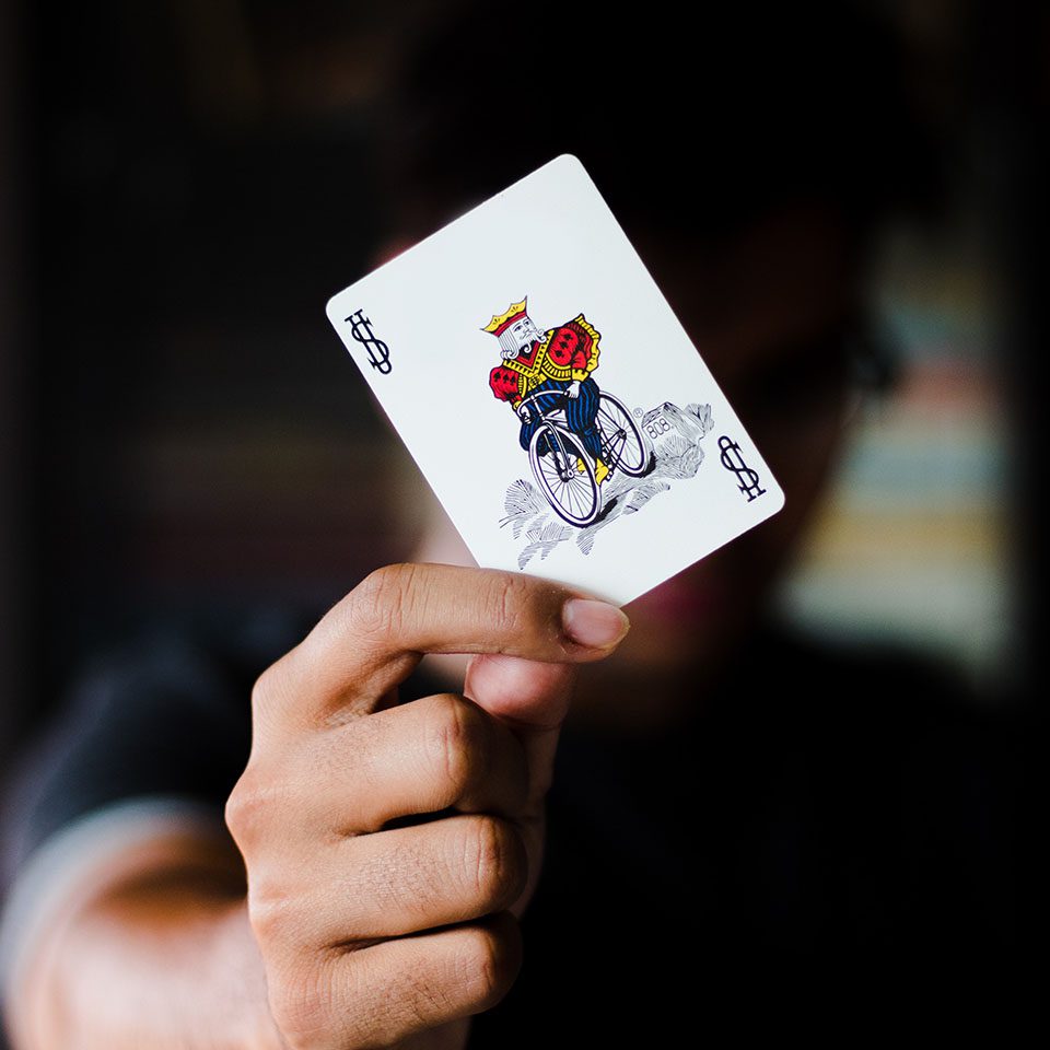 a playing card with a drawing of the Jack in a wheelchair