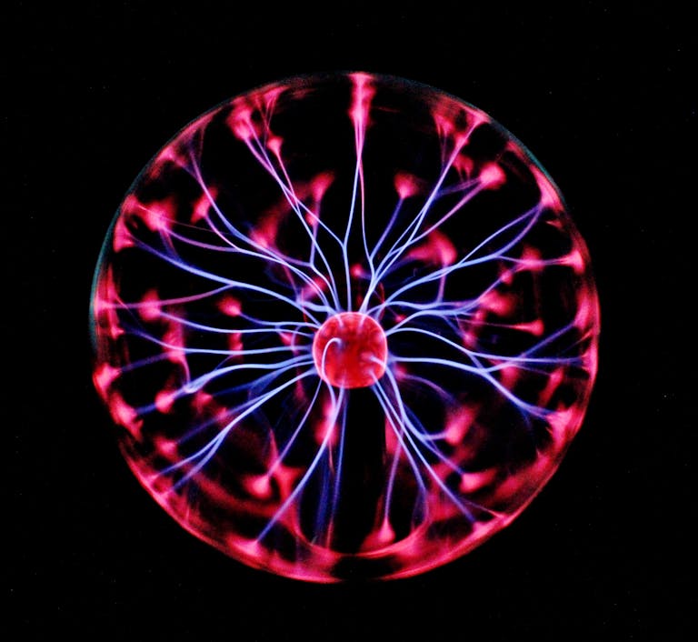 Close-up of a plasma globe with vibrant neon sparks against a dark background. AI Tools for Marketing.